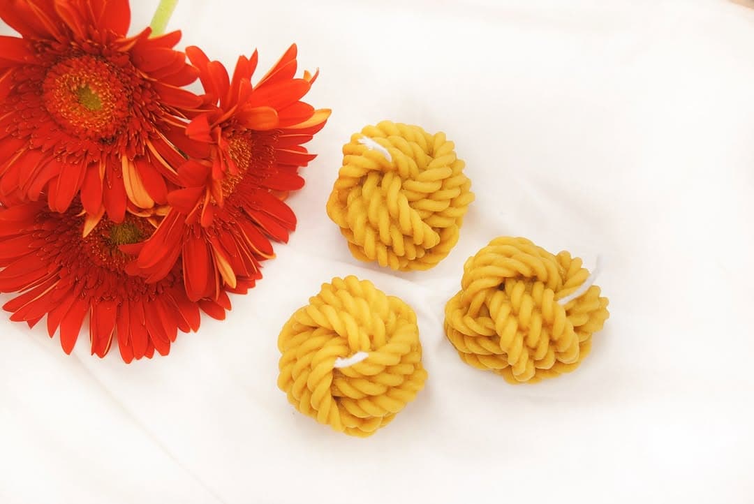 Lit beeswax candle in a quiet evening